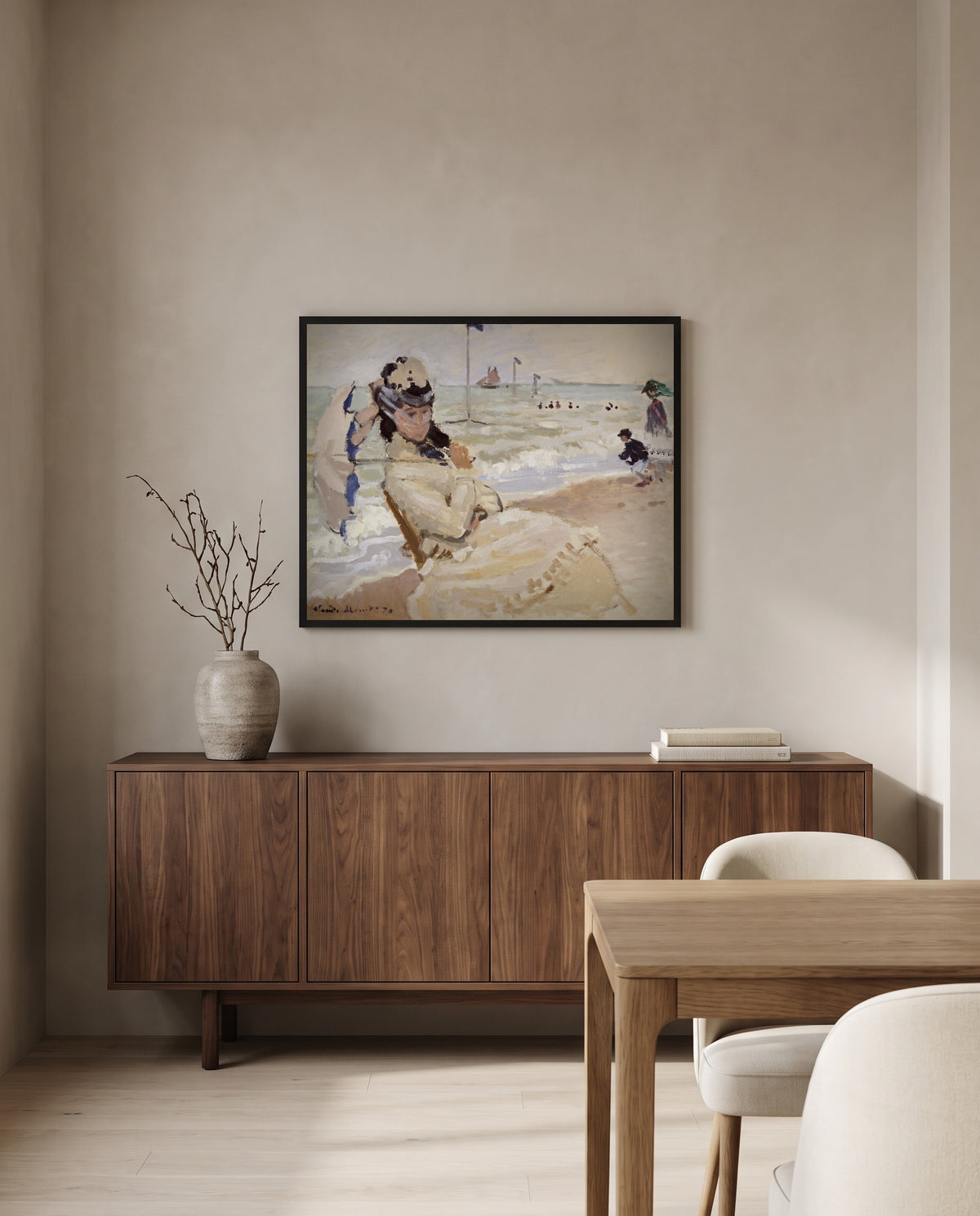 Camille on the Beach by Claude Monet in a black frame above a walnut sideboard in a dining room