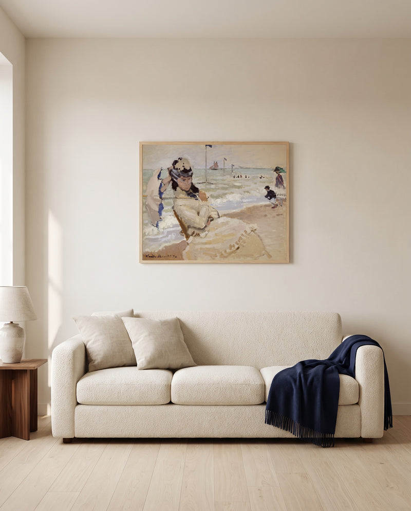 Camille on the Beach by Claude Monet framed in natural oak above a cream sofa in a warm living room