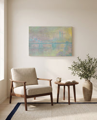 Charing Cross Bridge by Claude Monet as a stretched canvas above a linen lounge chair in a reading corner
