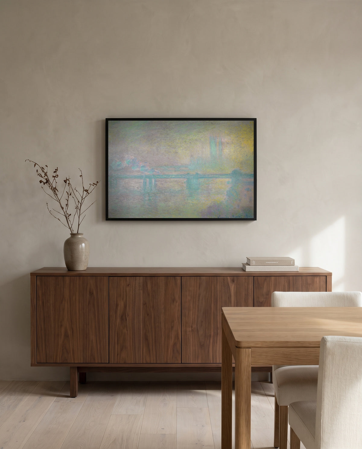 Charing Cross Bridge by Claude Monet in a black frame above a walnut sideboard in a dining room