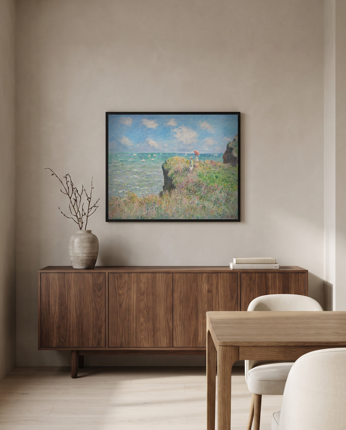 Cliff Walk at Pourville by Claude Monet in a black frame above a walnut sideboard in a dining room