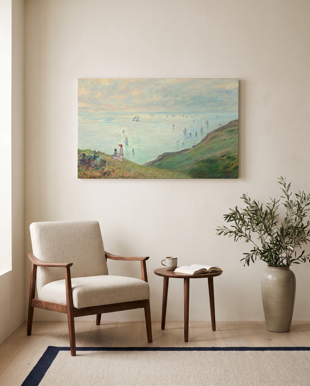 Cliffs at Pourville by Claude Monet as a stretched canvas above a linen lounge chair in a reading corner