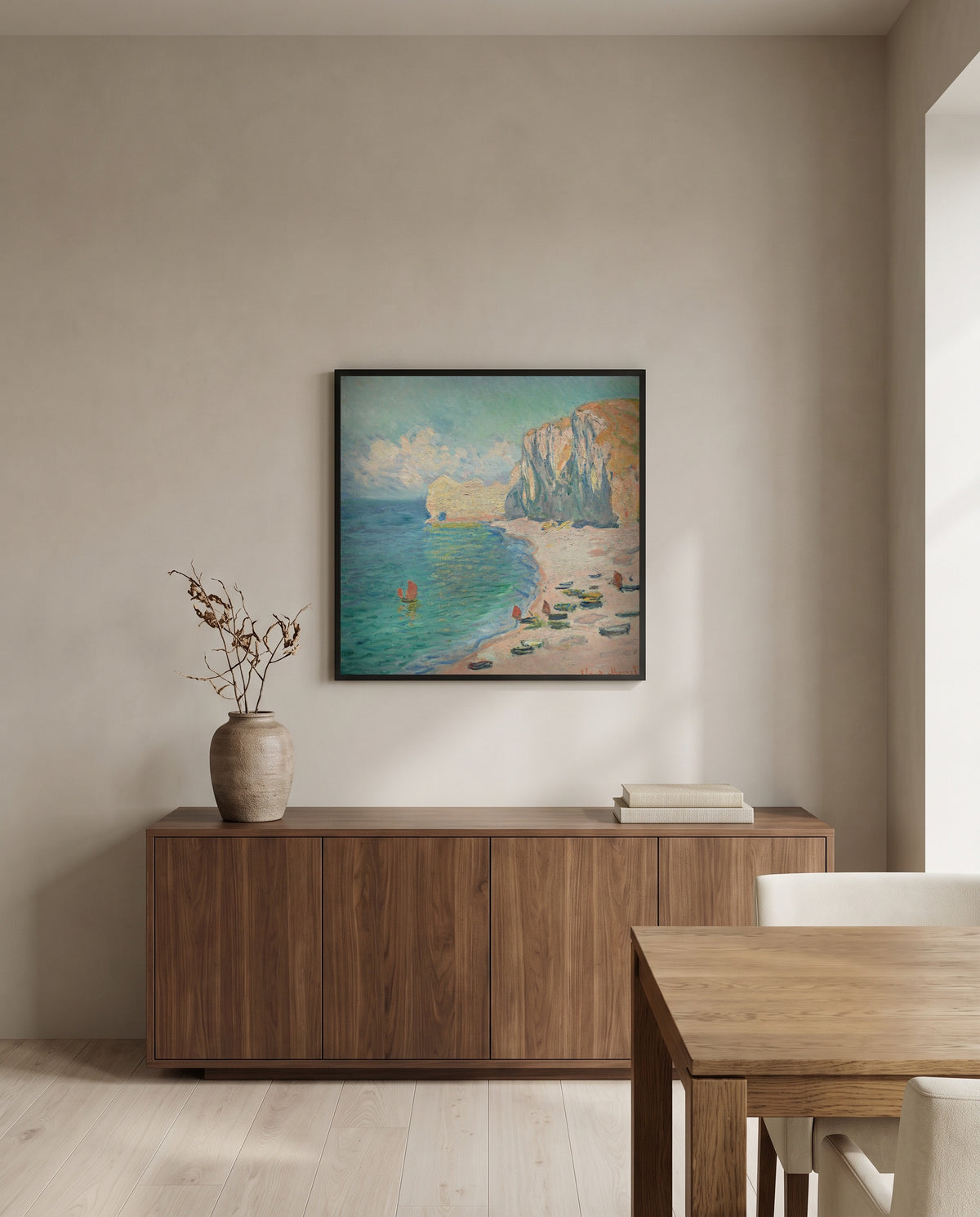 Étretat, Falaise d’Amont by Claude Monet in a black frame above a walnut sideboard in a dining room