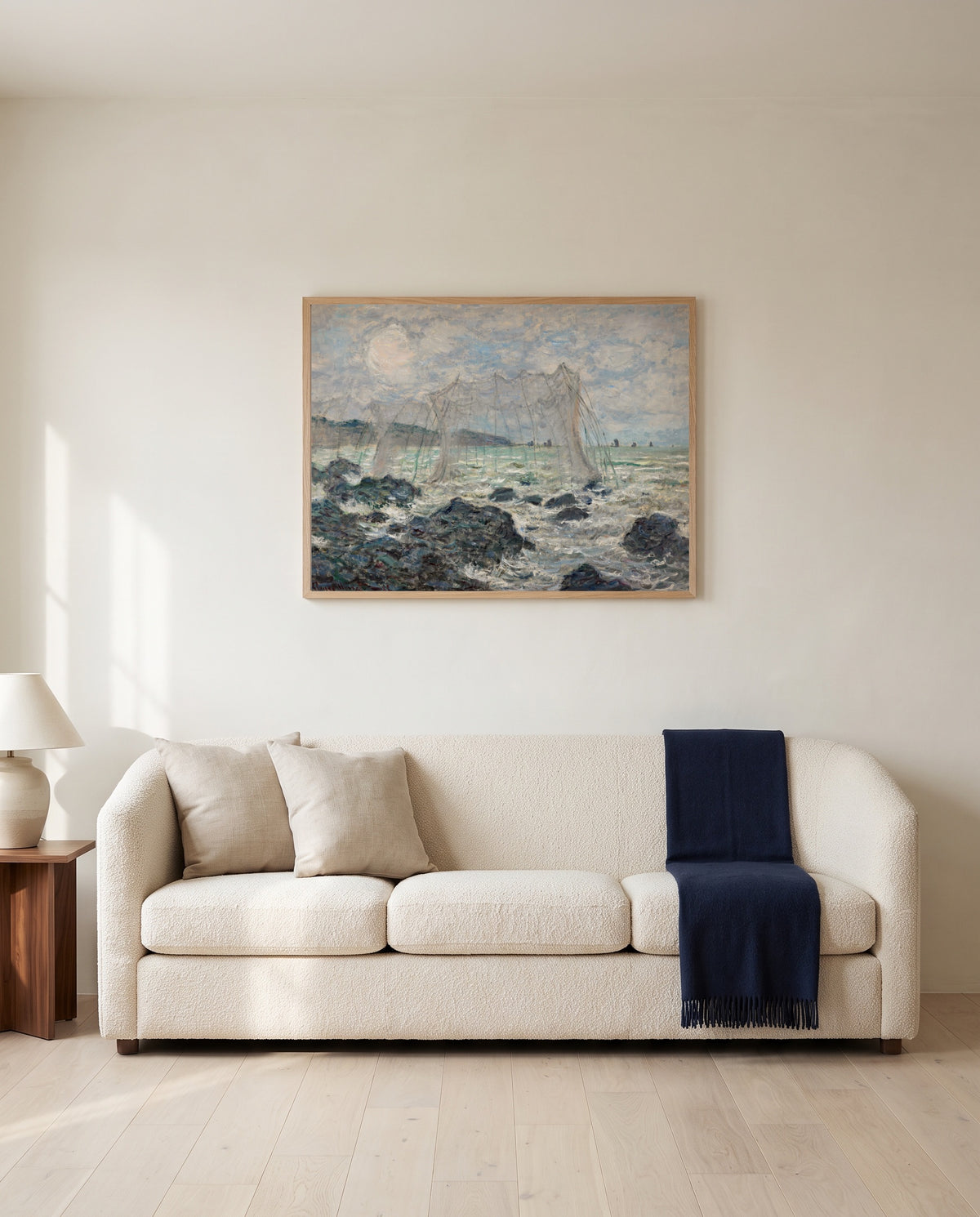 Fishing Nets at Pourville by Claude Monet framed in natural oak above a cream sofa in a warm living room