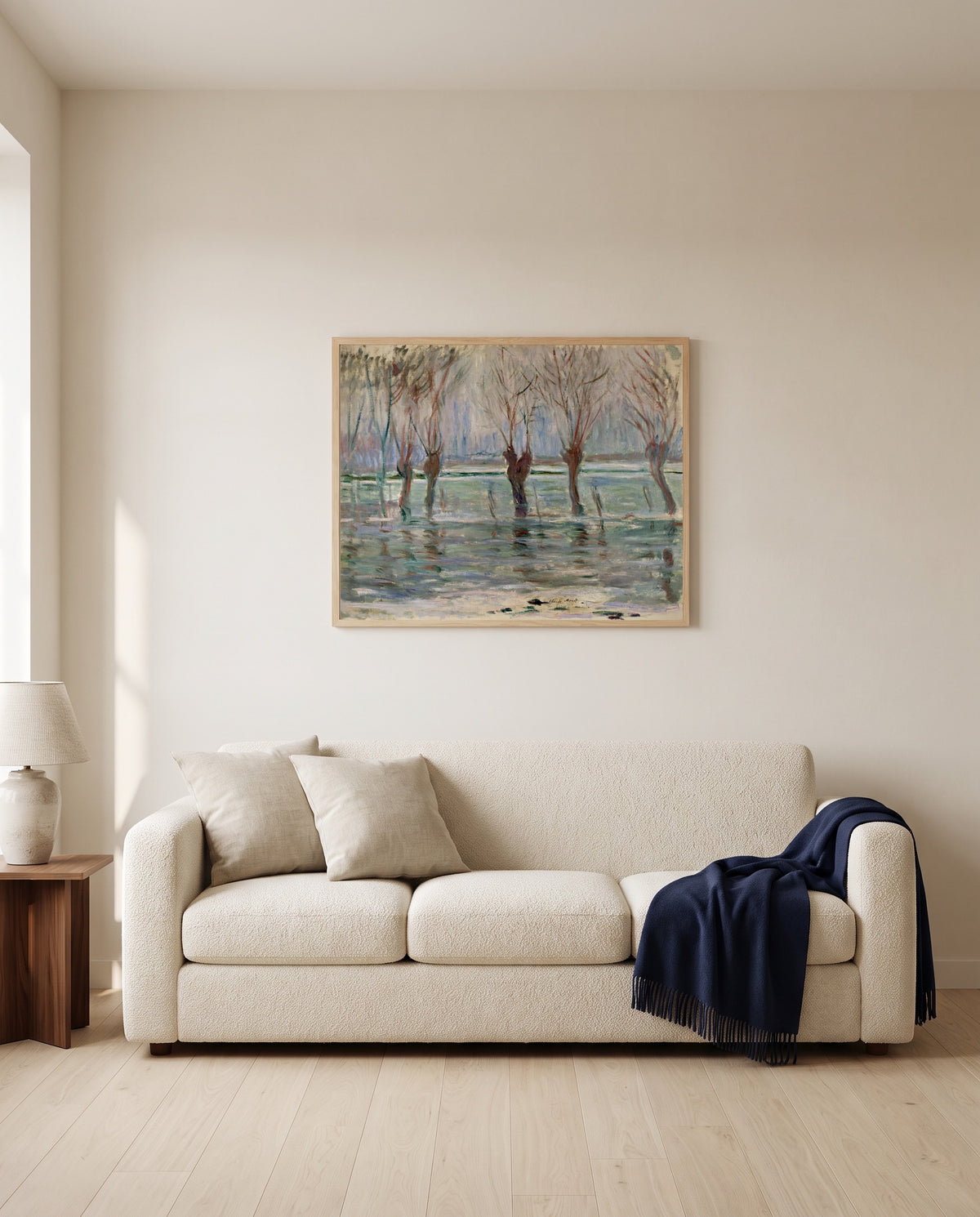 Flood Waters by Claude Monet framed in natural oak above a cream sofa in a warm living room