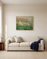 Plum Trees in Blossom by Claude Monet framed in natural oak above a cream sofa in a warm living room
