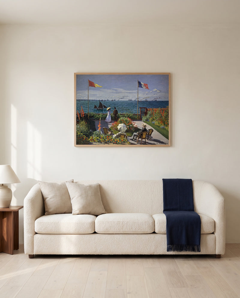 Garden at Sainte-Adresse by Claude Monet framed in natural oak above a cream sofa in a warm living room