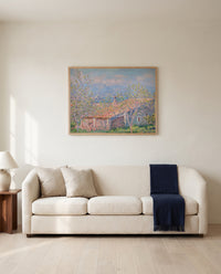 Gardener’s House at Antibes by Claude Monet framed in natural oak above a cream sofa in a warm living room