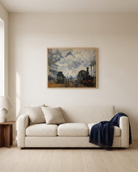 Gare Saint-Lazare by Claude Monet framed in natural oak above a cream sofa in a warm living room
