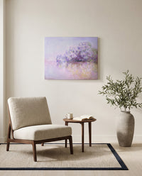 Île aux Orties by Claude Monet as a stretched canvas above a linen lounge chair in a reading corner