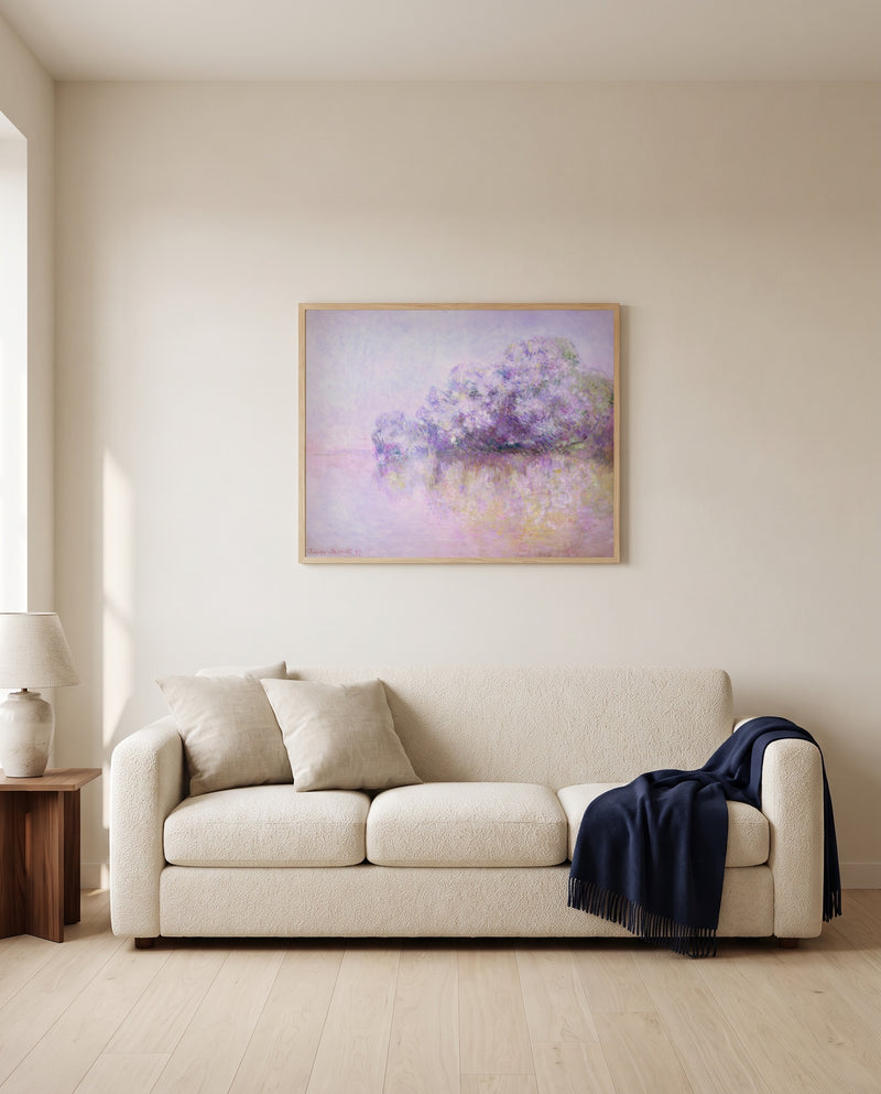 Île aux Orties by Claude Monet framed in natural oak above a cream sofa in a warm living room