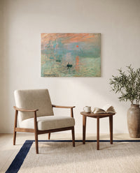 Impression, Sunrise by Claude Monet as a stretched canvas above a linen lounge chair in a reading corner