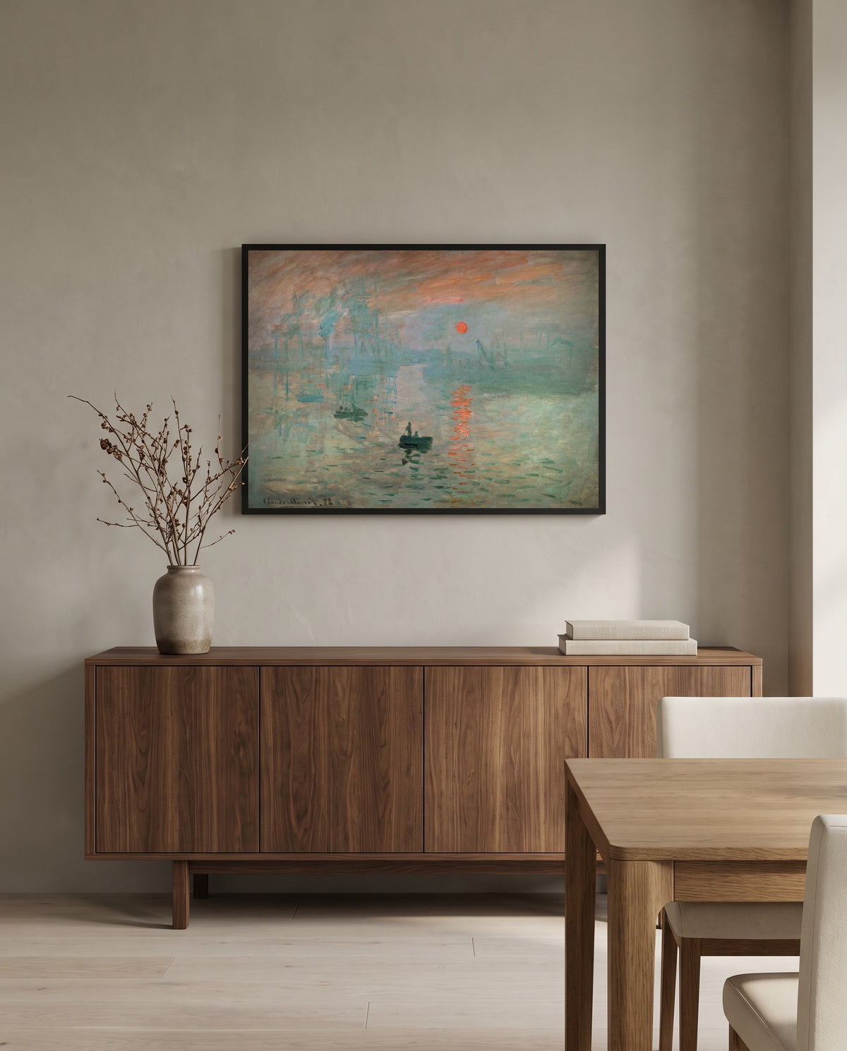Impression, Sunrise by Claude Monet in a black frame above a walnut sideboard in a dining room