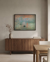 Impression, Sunrise by Claude Monet in a black frame above a walnut sideboard in a dining room