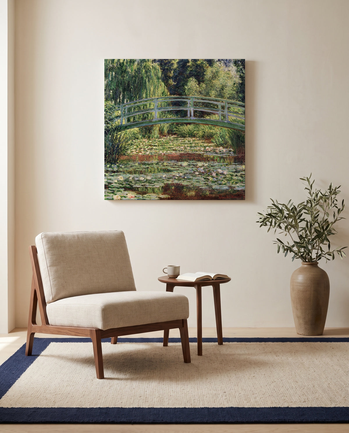 Japanese Footbridge, Giverny by Claude Monet as a stretched canvas above a linen lounge chair in a reading corner