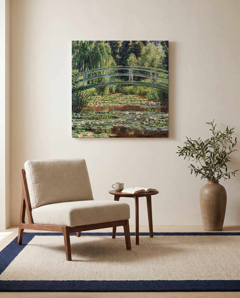 Japanese Footbridge, Giverny by Claude Monet as a stretched canvas above a linen lounge chair in a reading corner