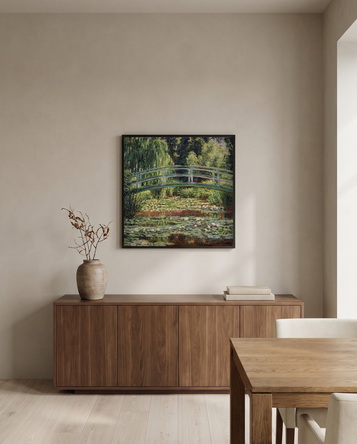 Japanese Footbridge, Giverny by Claude Monet in a black frame above a walnut sideboard in a dining room