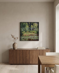 Japanese Footbridge, Giverny by Claude Monet in a black frame above a walnut sideboard in a dining room