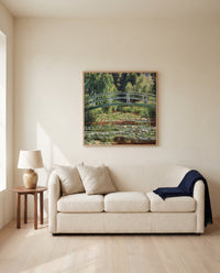 Japanese Footbridge, Giverny by Claude Monet framed in natural oak above a cream sofa in a warm living room