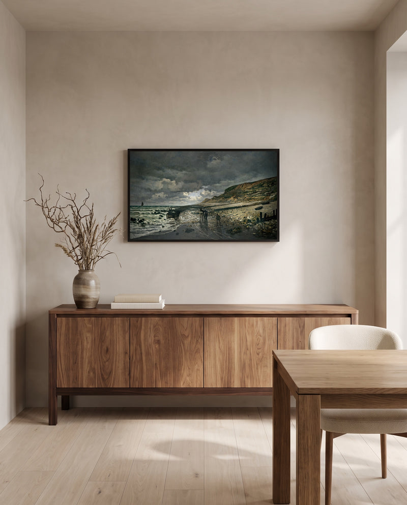 Pointe de la Hève, Low Tide by Claude Monet in a black frame above a walnut sideboard in a dining room