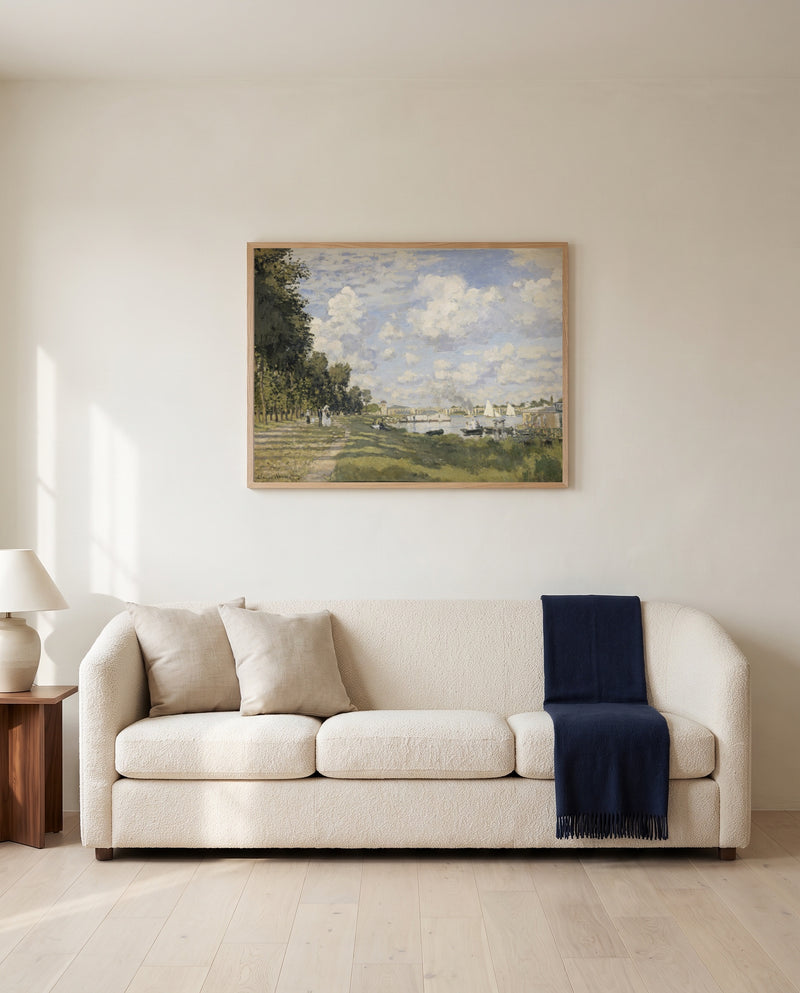 Le Bassin d’Argenteuil by Claude Monet framed in natural oak above a cream sofa in a warm living room