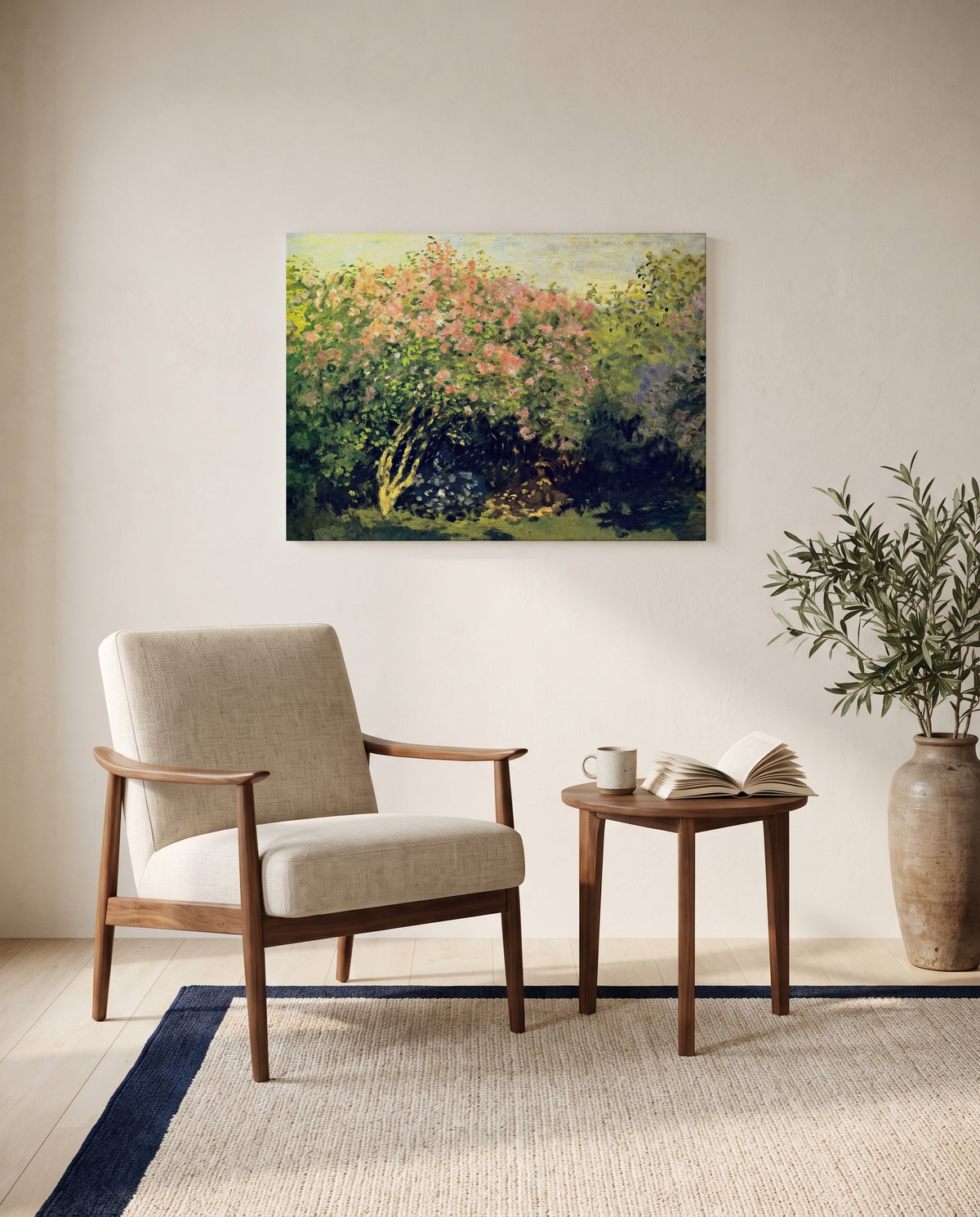Lilac Bush in the Sun by Claude Monet as a stretched canvas above a linen lounge chair in a reading corner