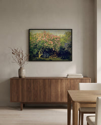 Lilac Bush in the Sun by Claude Monet in a black frame above a walnut sideboard in a dining room