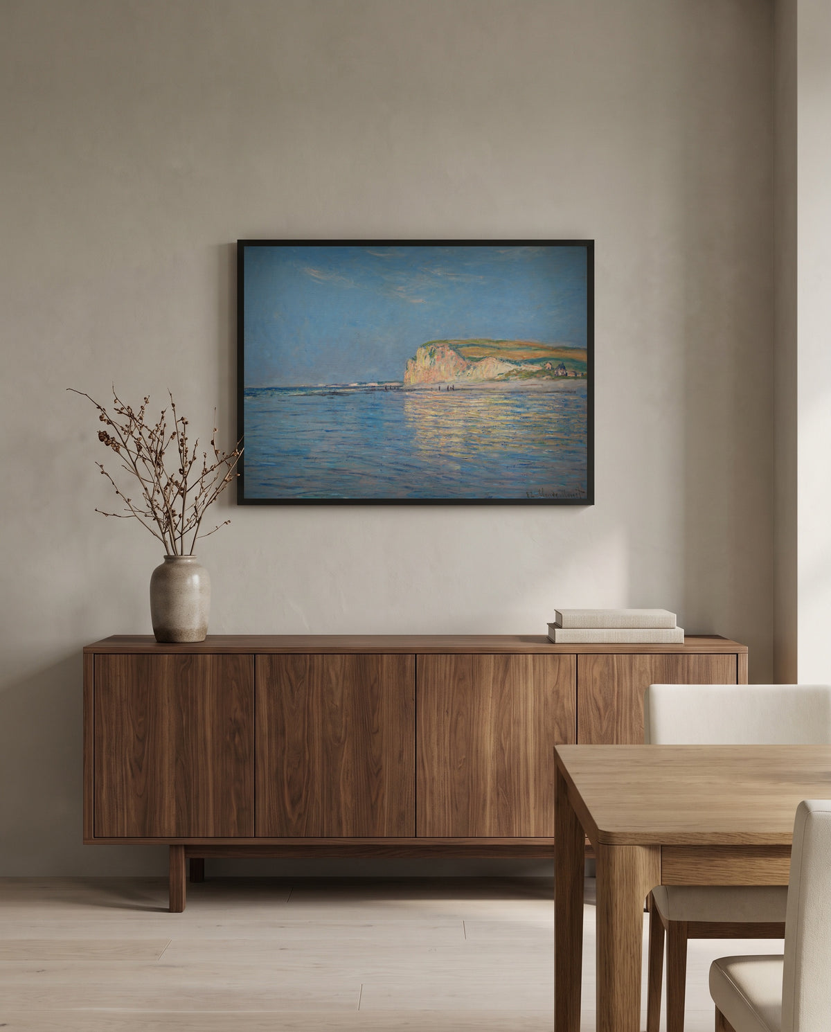 Low Tide at Pourville by Claude Monet in a black frame above a walnut sideboard in a dining room