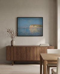 Low Tide at Pourville by Claude Monet in a black frame above a walnut sideboard in a dining room