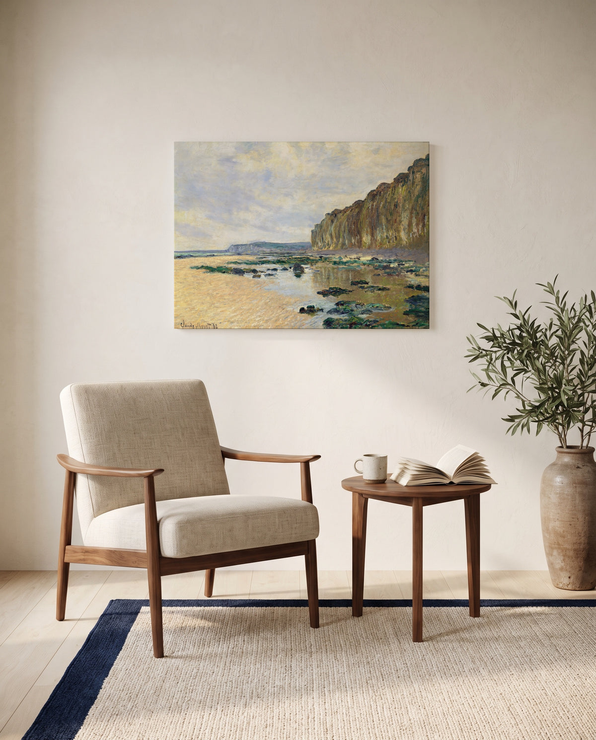 Low Tide at Varengeville by Claude Monet as a stretched canvas above a linen lounge chair in a reading corner