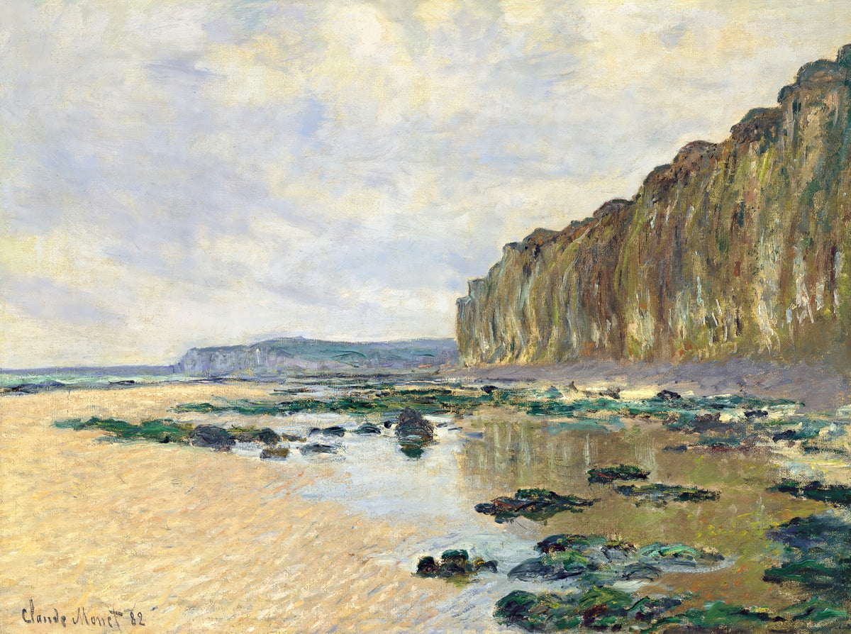 Low Tide at Varengeville by Claude Monet: tide pools on a wide beach below tall green cliffs, a pale cloudy sky