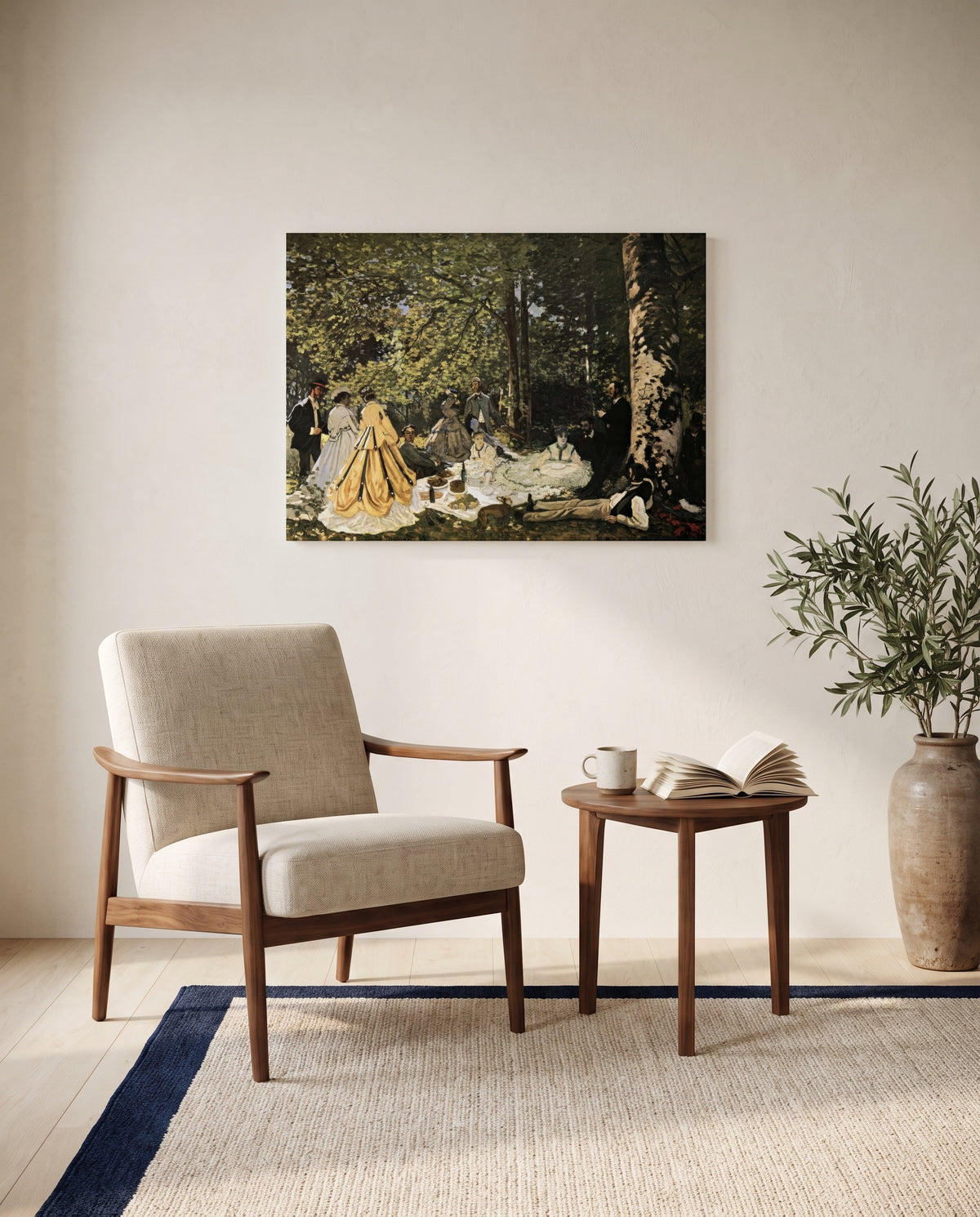Luncheon on the Grass by Claude Monet as a stretched canvas above a linen lounge chair in a reading corner