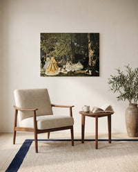 Luncheon on the Grass by Claude Monet as a stretched canvas above a linen lounge chair in a reading corner