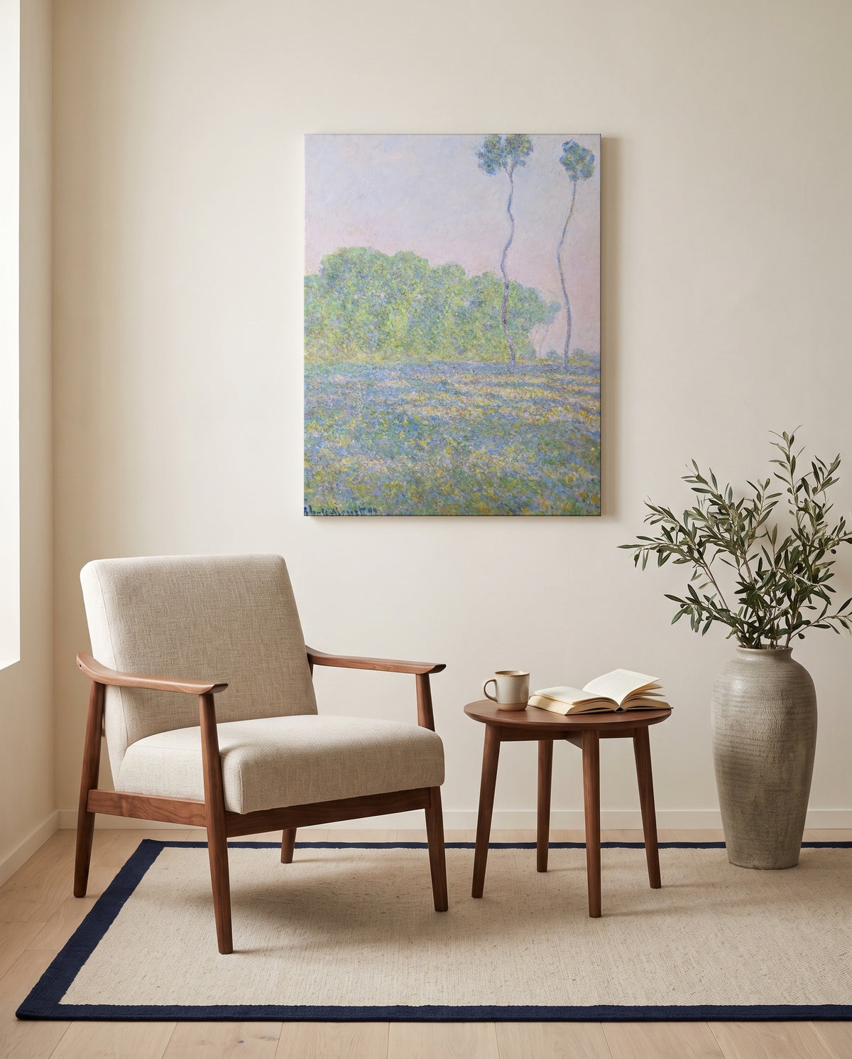 Meadow at Giverny by Claude Monet as a stretched canvas above a linen lounge chair in a reading corner