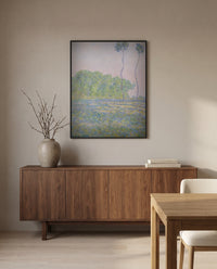 Meadow at Giverny by Claude Monet in a black frame above a walnut sideboard in a dining room