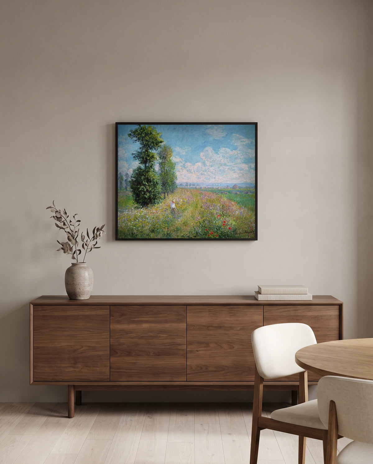 Meadow with Poplars by Claude Monet in a black frame above a walnut sideboard in a dining room