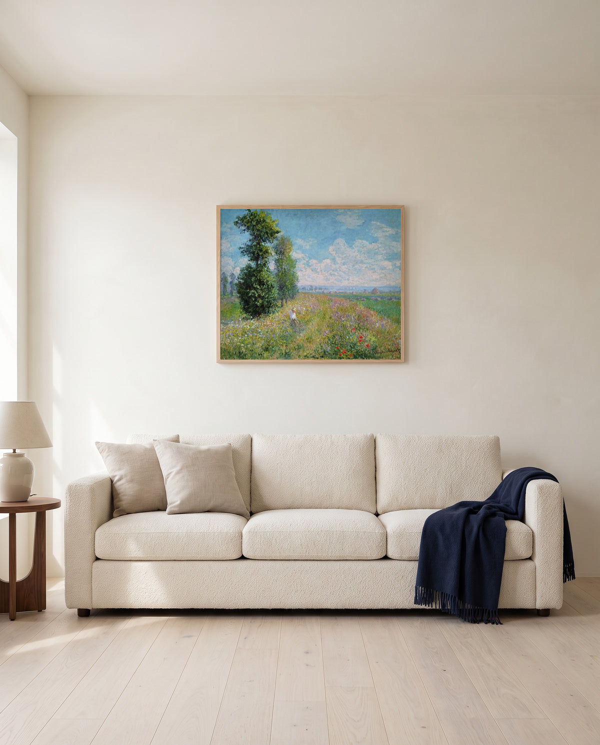 Meadow with Poplars by Claude Monet framed in natural oak above a cream sofa in a warm living room