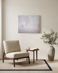 Morning Haze by Claude Monet as a stretched canvas above a linen lounge chair in a reading corner