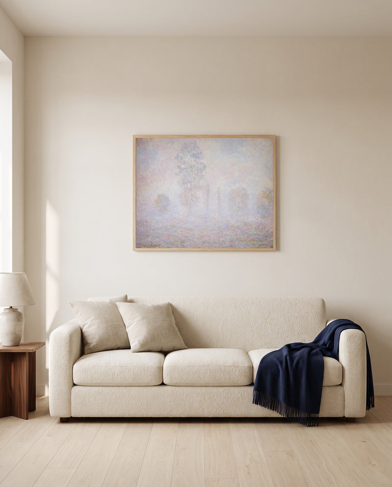Morning Haze by Claude Monet framed in natural oak above a cream sofa in a warm living room