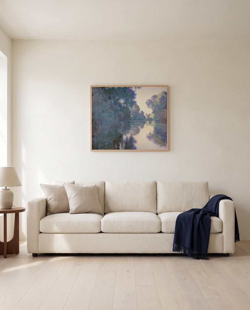 Morning on the Seine by Claude Monet framed in natural oak above a cream sofa in a warm living room