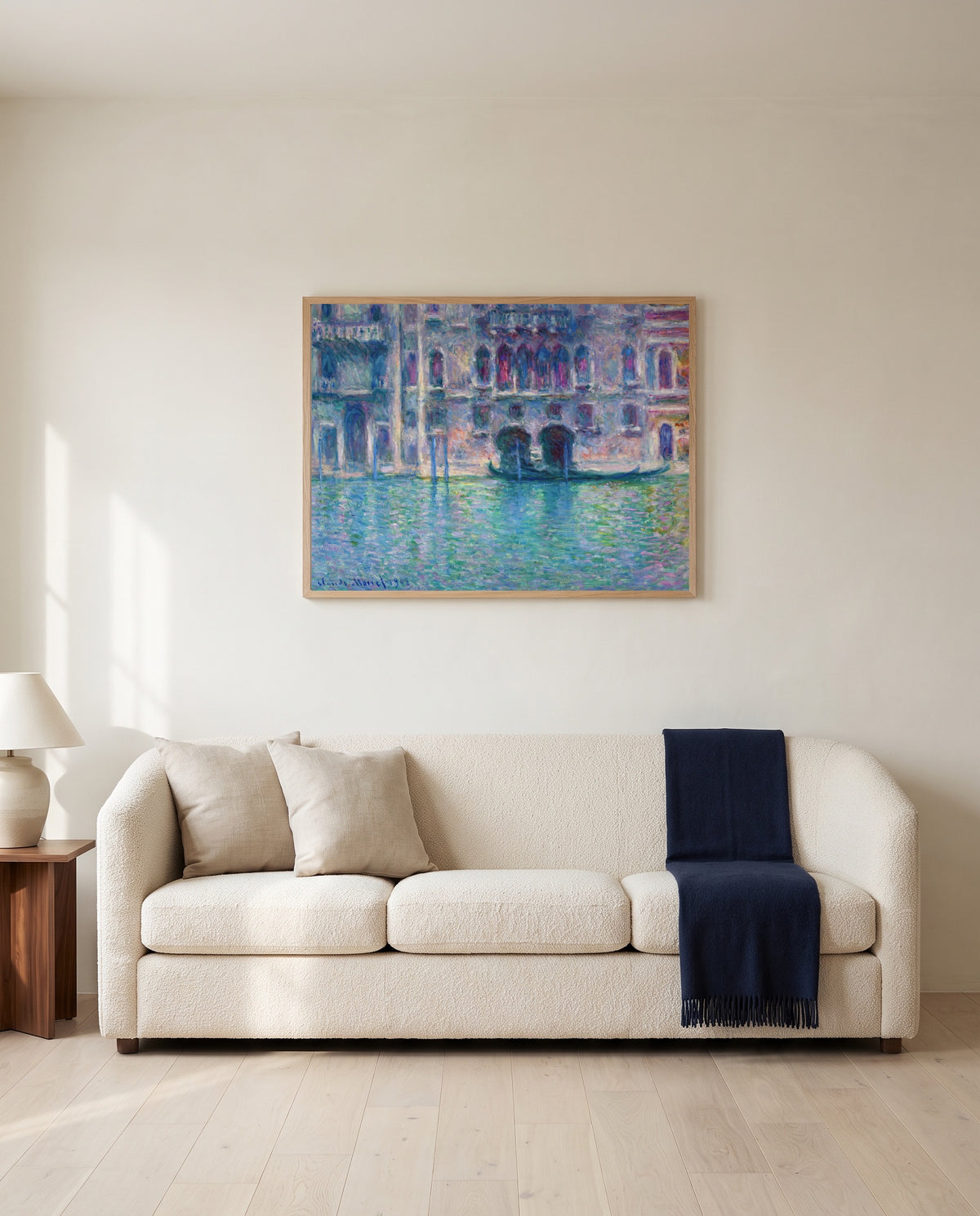 Palazzo da Mula by Claude Monet framed in natural oak above a cream sofa in a warm living room