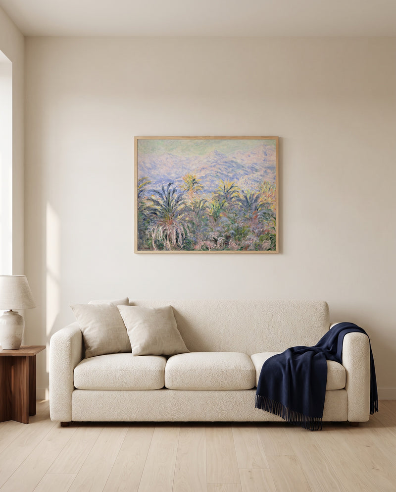 Palm Trees at Bordighera by Claude Monet framed in natural oak above a cream sofa in a warm living room