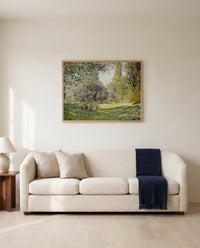 Landscape: The Parc Monceau by Claude Monet framed in natural oak above a cream sofa in a warm living room