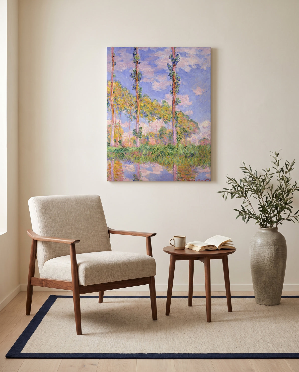 Poplars in the Sun by Claude Monet as a stretched canvas above a linen lounge chair in a reading corner