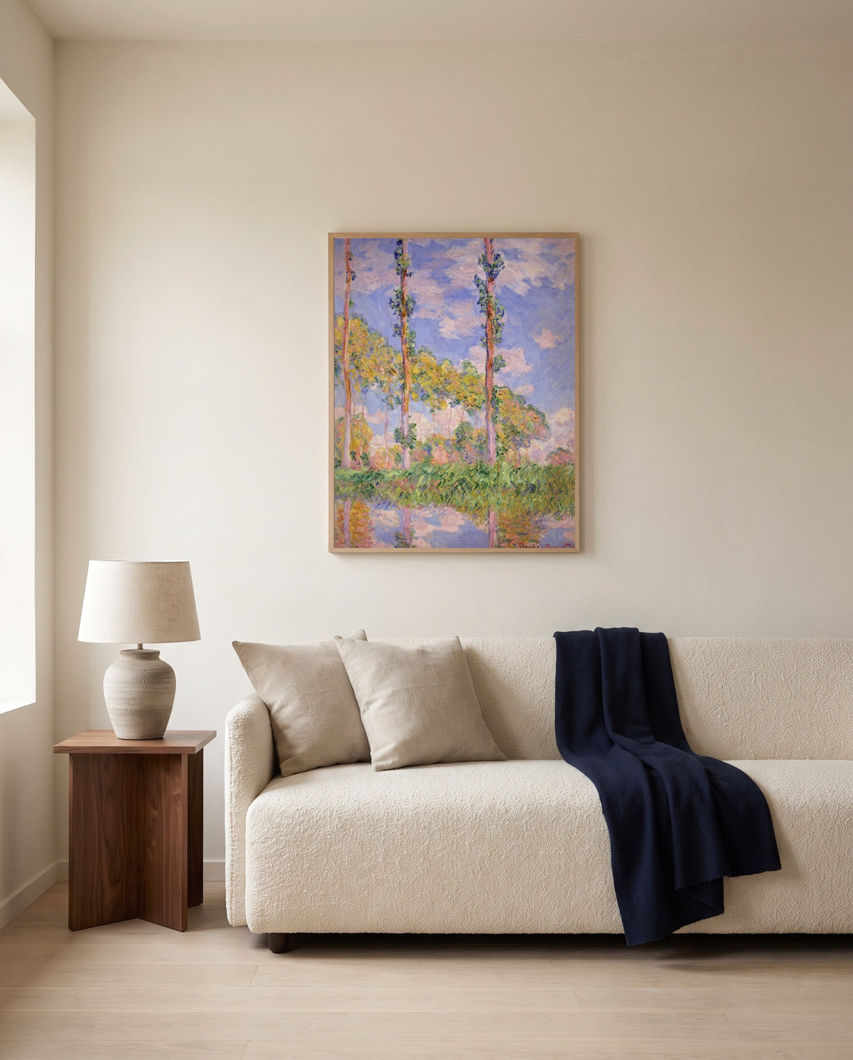 Poplars in the Sun by Claude Monet framed in natural oak above a cream sofa in a warm living room