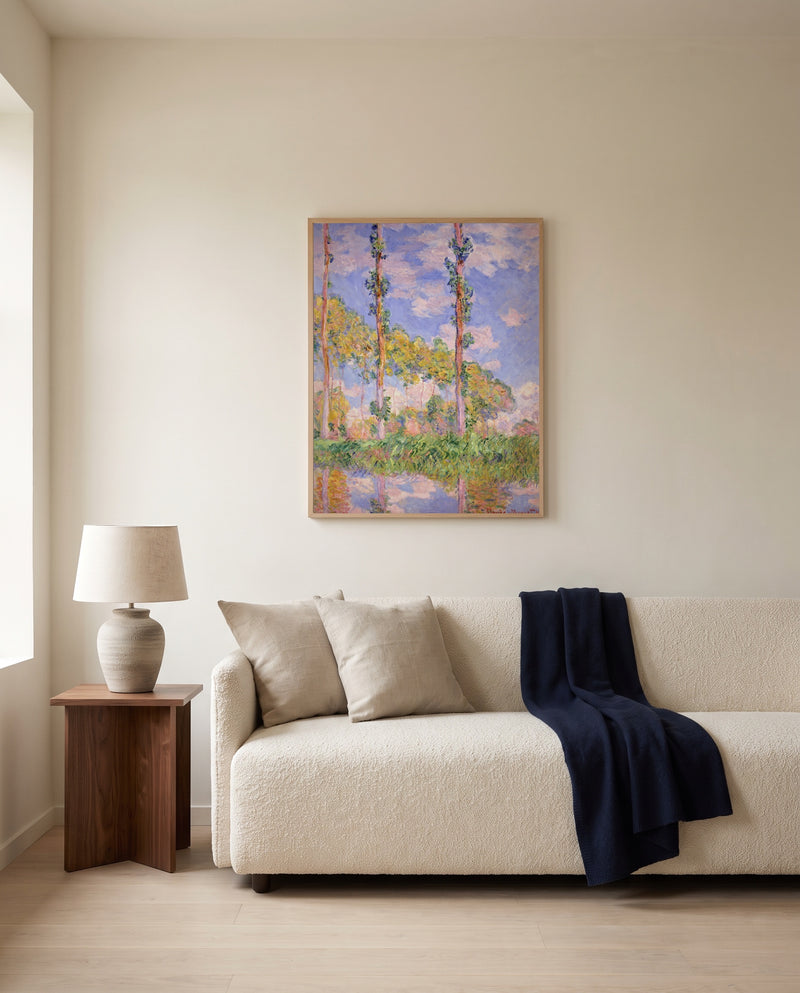 Poplars in the Sun by Claude Monet framed in natural oak above a cream sofa in a warm living room