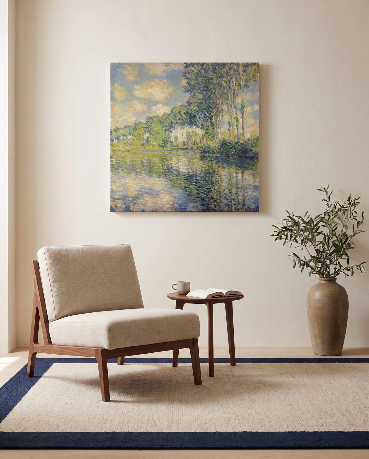 Poplars on the Epte by Claude Monet as a stretched canvas above a linen lounge chair in a reading corner