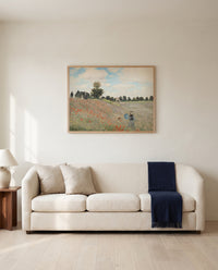 Poppies by Claude Monet framed in natural oak above a cream sofa in a warm living room