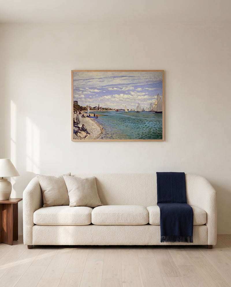 Regatta at Sainte-Adresse by Claude Monet framed in natural oak above a cream sofa in a warm living room