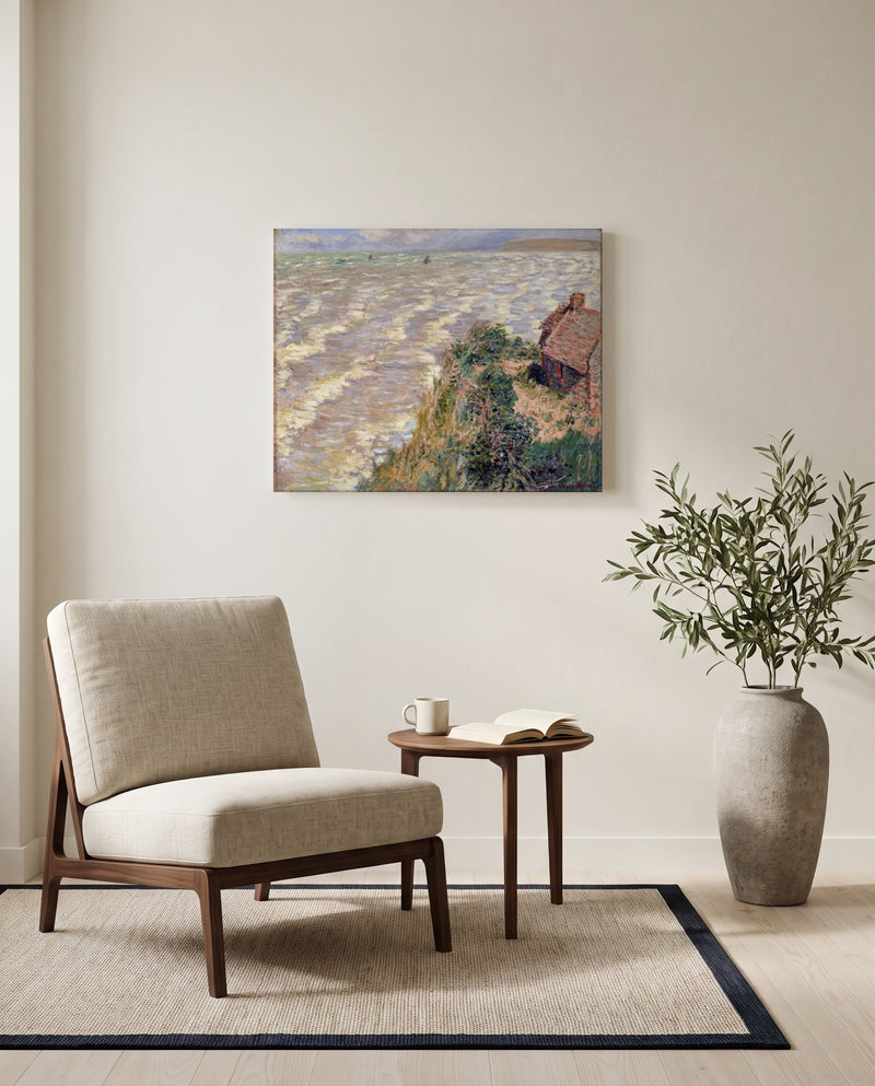 Rising Tide at Pourville by Claude Monet as a stretched canvas above a linen lounge chair in a reading corner